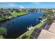 Picturesque backyard featuring a waterfront canal, private boat dock, and lush tropical landscaping at 531 Madrid Blvd, Punta Gorda, FL 33950