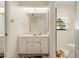 Bathroom featuring a vanity, a toilet, and a window that brightens the space with natural light at 531 Madrid Blvd, Punta Gorda, FL 33950