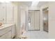 Well-lit bathroom showcasing tiled flooring, a skylight, and doorways to the shower and mirrored closet at 531 Madrid Blvd, Punta Gorda, FL 33950