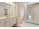 Bathroom with a vanity, tiled floors, a shower with glass doors, and a bright, open feel at 531 Madrid Blvd, Punta Gorda, FL 33950