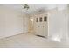 Bedroom featuring tiled floors, closet, and a doorway, providing a spacious and versatile area at 531 Madrid Blvd, Punta Gorda, FL 33950
