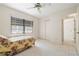 Bedroom with tiled floors, a floral bedspread, large window, and a closet for storage at 531 Madrid Blvd, Punta Gorda, FL 33950