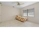 Cozy bedroom with tiled flooring, ceiling fan, and natural light from the large window at 531 Madrid Blvd, Punta Gorda, FL 33950