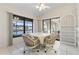 Cozy breakfast nook features waterfront views, white tile flooring, and wicker rolling chairs at 531 Madrid Blvd, Punta Gorda, FL 33950