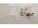 Bright dining area with a glass table and decorative chandelier adjacent to the home's double door entry at 531 Madrid Blvd, Punta Gorda, FL 33950