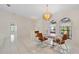 Inviting dining room with a glass table set, chandelier, and arched windows that bring in natural light at 531 Madrid Blvd, Punta Gorda, FL 33950