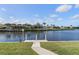 Scenic view of a private dock extending into the tranquil canal, surrounded by lush landscaping at 531 Madrid Blvd, Punta Gorda, FL 33950