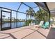 Enclosed patio featuring outdoor seating with views of the tranquil canal, perfect for relaxation and entertaining at 531 Madrid Blvd, Punta Gorda, FL 33950