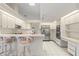 Bright kitchen featuring white cabinets, stainless steel appliances, and a cozy breakfast bar with seating at 531 Madrid Blvd, Punta Gorda, FL 33950