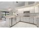 Bright kitchen with white cabinets, stainless steel appliances, eat-in breakfast bar, and views of the water at 531 Madrid Blvd, Punta Gorda, FL 33950