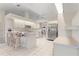 Spacious white kitchen with breakfast bar, stainless steel appliances, and ample counter space for cooking at 531 Madrid Blvd, Punta Gorda, FL 33950