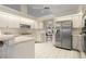 Bright eat-in kitchen featuring white cabinets, stainless steel appliances and a view of the water outside at 531 Madrid Blvd, Punta Gorda, FL 33950