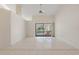 Bright living room featuring high ceilings, tile floors, and sliding glass doors to the outdoor pool area at 531 Madrid Blvd, Punta Gorda, FL 33950