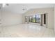 Spacious living room featuring tile floors, a vaulted ceiling, and large bay windows at 531 Madrid Blvd, Punta Gorda, FL 33950