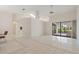 Bright living room featuring tile flooring, high ceilings, and sliding glass doors to outdoor patio at 531 Madrid Blvd, Punta Gorda, FL 33950