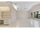 Open living room with tile floors, neutral paint, built in desk, and large windows at 531 Madrid Blvd, Punta Gorda, FL 33950