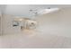 Open floor plan with tile flooring, ceiling fan, kitchen view, and natural light at 531 Madrid Blvd, Punta Gorda, FL 33950