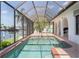 Relaxing screened-in pool area with waterfront views and comfortable lounge chairs at 531 Madrid Blvd, Punta Gorda, FL 33950