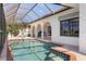 Screened pool and spa with scenic canal views, framed by arches that offer privacy and outdoor enjoyment at 531 Madrid Blvd, Punta Gorda, FL 33950