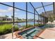Screened in pool and spa featuring waterfront views and lush landscape at 531 Madrid Blvd, Punta Gorda, FL 33950