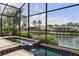 Screened pool and spa with scenic canal views, perfect for relaxation and private outdoor enjoyment at 531 Madrid Blvd, Punta Gorda, FL 33950