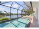 Screened pool with canal views, offering a tranquil outdoor space for relaxation and waterfront enjoyment at 531 Madrid Blvd, Punta Gorda, FL 33950