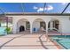 Covered poolside patio with outdoor seating, offering a comfortable space for relaxation and canal views at 531 Madrid Blvd, Punta Gorda, FL 33950