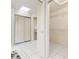 Walk-in closet featuring shelving, a mirrored door, and ensuite bathroom at 531 Madrid Blvd, Punta Gorda, FL 33950