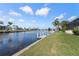 Beautiful waterfront property featuring a private dock, lush landscaping, and serene canal views at 531 Madrid Blvd, Punta Gorda, FL 33950