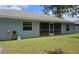 Exterior view of home with screened in porch, windows, and lawn at 6341 Opa Locka Ln, North Port, FL 34291