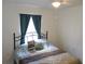 Bedroom featuring a comfortable queen bed with decorative pillows and window with curtains at 6341 Opa Locka Ln, North Port, FL 34291