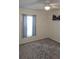 Cozy bedroom with neutral carpeting and a large window with curtains, illuminated by a ceiling fan at 6341 Opa Locka Ln, North Port, FL 34291