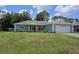 Well-maintained single-story home with a green lawn and an attached two-car garage at 6341 Opa Locka Ln, North Port, FL 34291