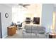 Open-concept living area featuring a neutral gray sofa and dining area leading to the kitchen at 6341 Opa Locka Ln, North Port, FL 34291