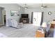 Spacious living room with ceiling fans, modern decor, comfortable seating, and ample natural light at 6341 Opa Locka Ln, North Port, FL 34291