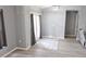 Bright living room area features French doors with a decorative rug on the gray wood-look flooring at 6341 Opa Locka Ln, North Port, FL 34291