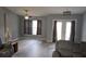 Bright living room featuring neutral paint, ceiling fan, wood-look flooring and comfortable seating at 6341 Opa Locka Ln, North Port, FL 34291