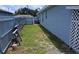 Side yard with fence and lush lawn at 6341 Opa Locka Ln, North Port, FL 34291