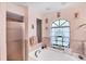 Bright bathroom features a large soaking tub and glass enclosed shower at 6514 N Biscayne Dr, North Port, FL 34291