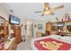 Spacious bedroom with ceiling fan, television and ensuite bath at 6514 N Biscayne Dr, North Port, FL 34291