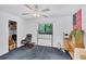 Bedroom with a ceiling fan and a window with backyard views at 6514 N Biscayne Dr, North Port, FL 34291