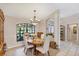 Dining room with large window, chandelier, and neutral color scheme at 6514 N Biscayne Dr, North Port, FL 34291