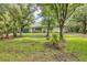 Well-maintained home featuring a spacious green lawn and mature trees at 6514 N Biscayne Dr, North Port, FL 34291