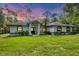 Charming single-story home with lush green lawn and well-maintained landscaping at 6514 N Biscayne Dr, North Port, FL 34291