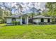 Charming single-story home with lush green lawn and well-maintained landscaping at 6514 N Biscayne Dr, North Port, FL 34291