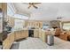 Open kitchen with granite countertops, stainless appliances, and access to living space at 6514 N Biscayne Dr, North Port, FL 34291