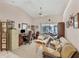 Bright living room with ceiling fan, sliding door, desk, and sofa at 6514 N Biscayne Dr, North Port, FL 34291