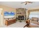 Cozy living room with a stone fireplace, TV, and comfortable seating area at 6514 N Biscayne Dr, North Port, FL 34291