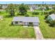 Aerial front view of a home with mature landscaping, and a driveway at 6540 Kenwood Dr, North Port, FL 34287