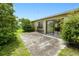 Backyard patio with sliding glass door access and lush landscaping at 6540 Kenwood Dr, North Port, FL 34287
